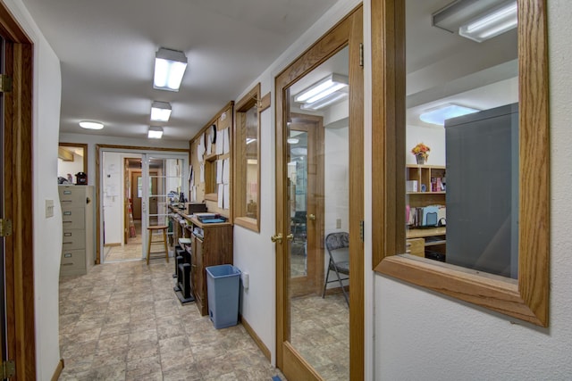 hall with light tile patterned flooring and french doors