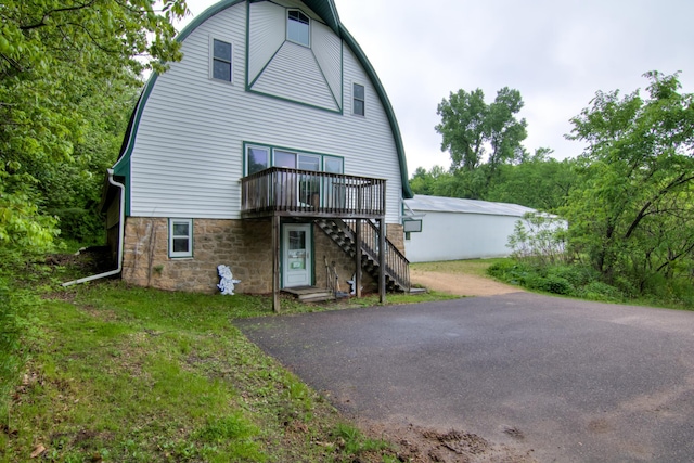 rear view of property featuring a yard