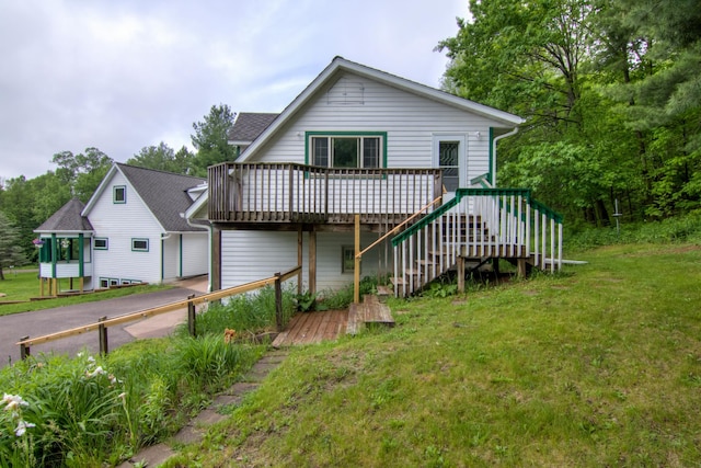 view of front of property with a wooden deck and a front lawn