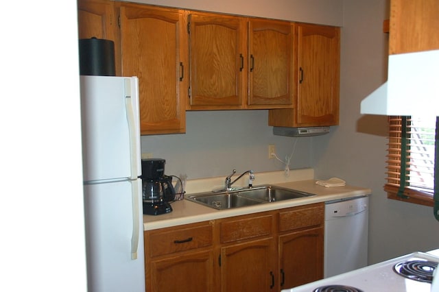 25124 Tame Fish Lake Rd Unit 550, Deerwood, MN 56444 - kitchen featuring white appliances, brown cabinetry, a sink, and light countertops