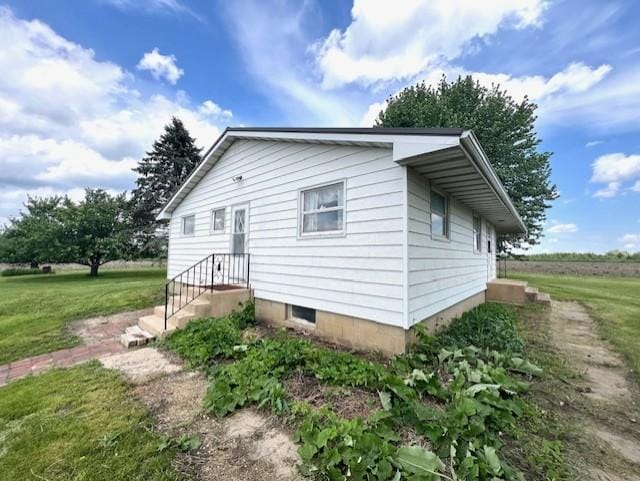 view of property exterior with a yard