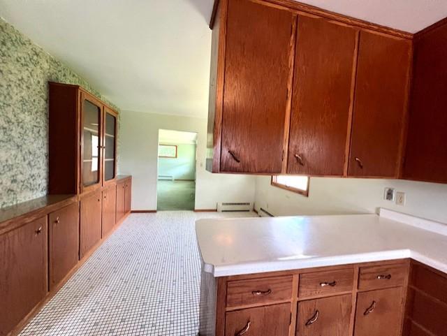 kitchen featuring light tile flooring and baseboard heating