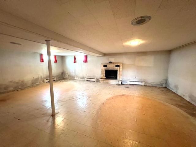 basement featuring baseboard heating and a fireplace