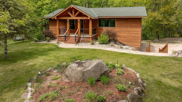 log home with a porch and a front lawn