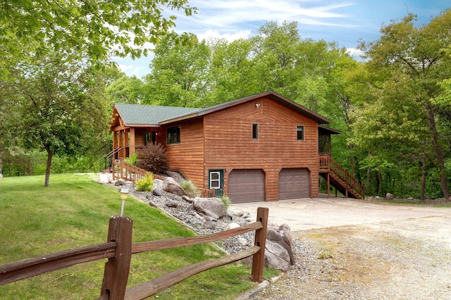 view of front of property featuring a garage, driveway, stairs, and a front lawn