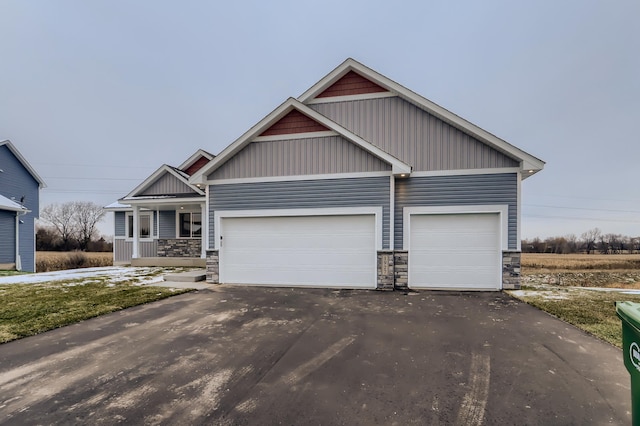 craftsman inspired home with a porch and a garage