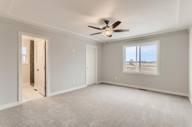 carpeted spare room featuring ceiling fan