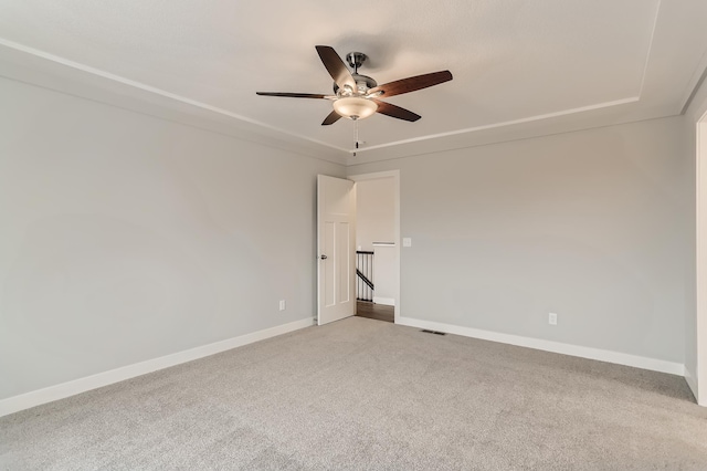 carpeted spare room with ceiling fan