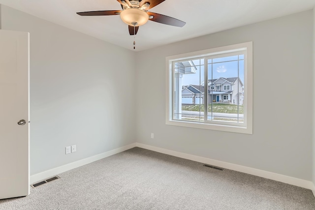 carpeted empty room featuring ceiling fan