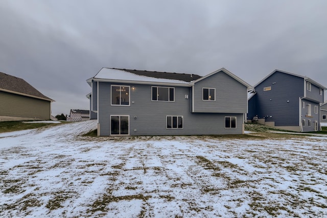 view of snow covered rear of property