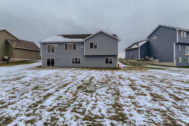 view of snow covered back of property