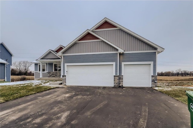 craftsman-style house featuring a garage and covered porch