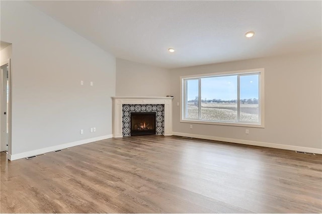 unfurnished living room featuring a fireplace and light wood-type flooring