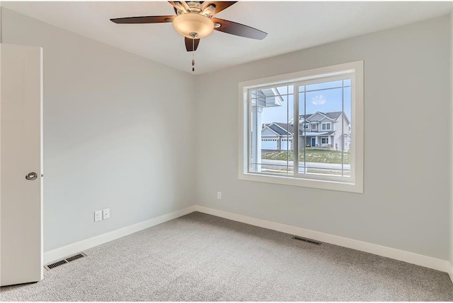 spare room featuring carpet and ceiling fan