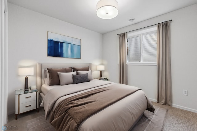carpeted bedroom featuring baseboards