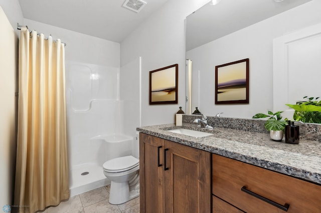 bathroom featuring visible vents, toilet, a shower stall, and vanity