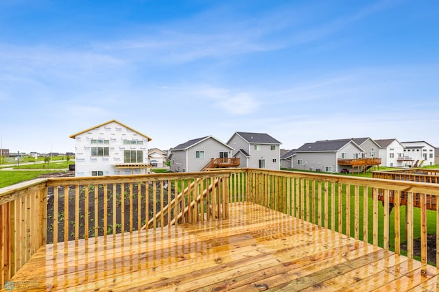 wooden deck with a yard and a residential view