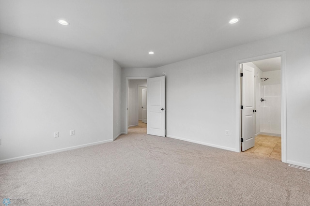 unfurnished bedroom featuring light carpet, recessed lighting, and baseboards