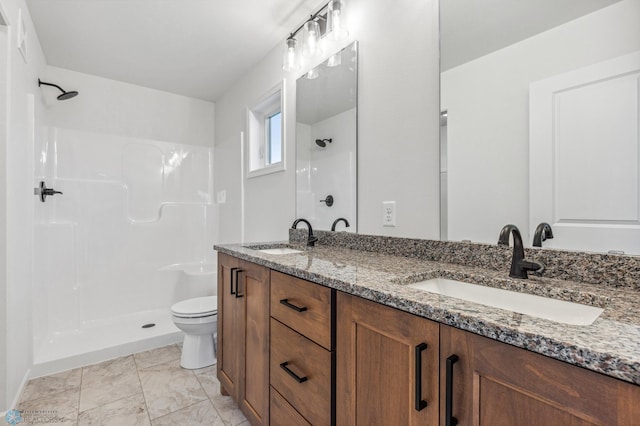 full bath with a shower, double vanity, a sink, and toilet