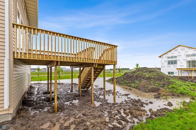 view of yard with a wooden deck and stairs