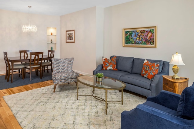 living room with wood-type flooring and a notable chandelier