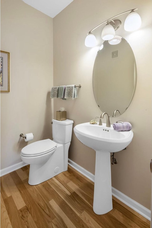 bathroom featuring toilet and hardwood / wood-style flooring