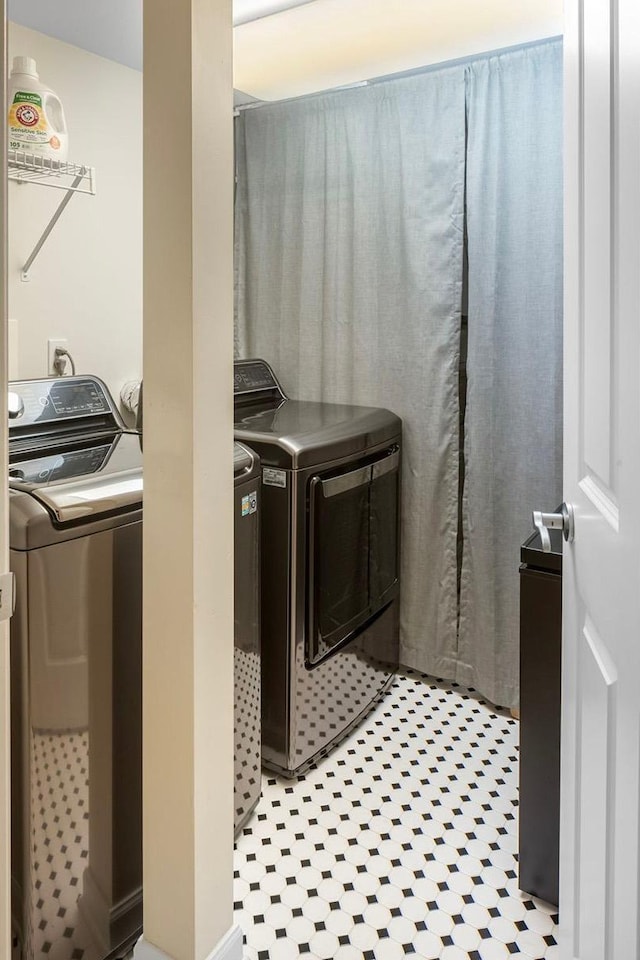 laundry room featuring washing machine and clothes dryer