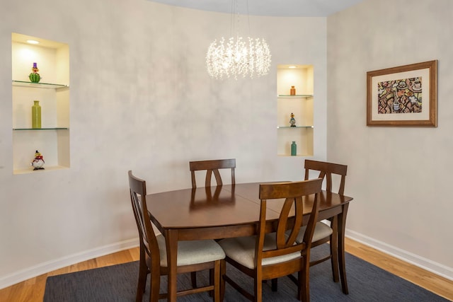 dining room with a notable chandelier and hardwood / wood-style flooring