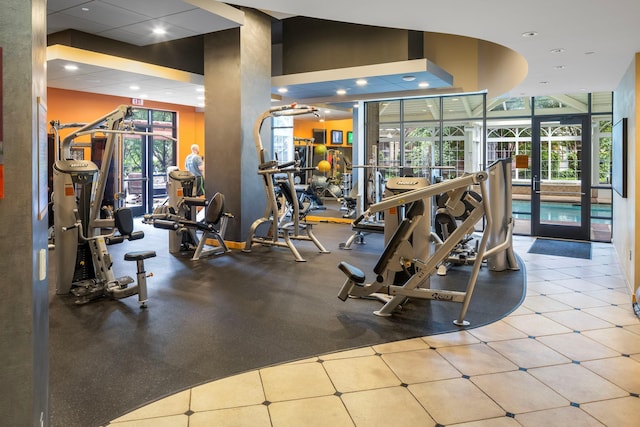 gym with floor to ceiling windows and a wealth of natural light