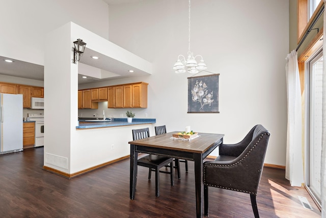 3799 Larabee Ave NE, Saint Michael, MN 55376 - dining room featuring dark wood-style floors, a chandelier, a towering ceiling, and recessed lighting