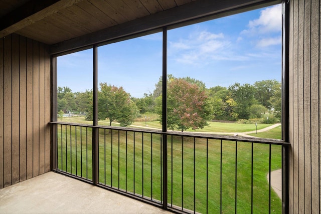 unfurnished sunroom featuring beam ceiling and wood ceiling