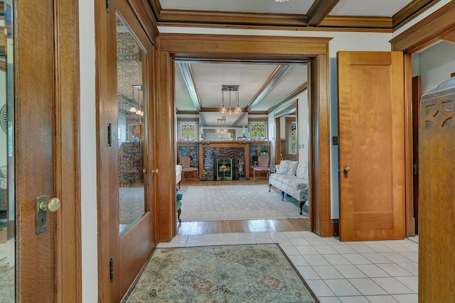 hall featuring beamed ceiling, light hardwood / wood-style flooring, and ornamental molding