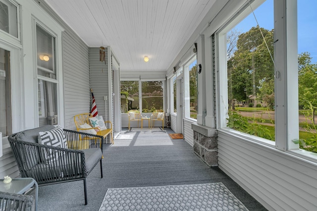 sunroom / solarium featuring wood ceiling