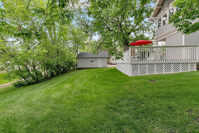 view of yard featuring a wooden deck and an outbuilding