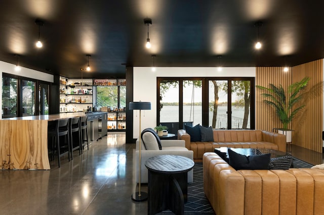 living room with a water view and indoor bar