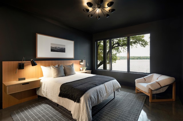 bedroom with a chandelier and a water view