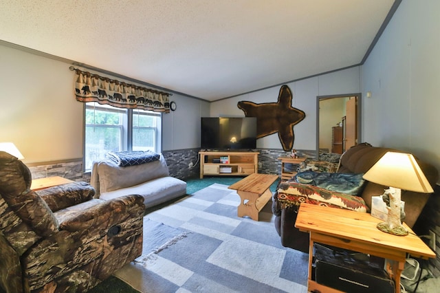 living room featuring lofted ceiling, a textured ceiling, ornamental molding, and carpet flooring