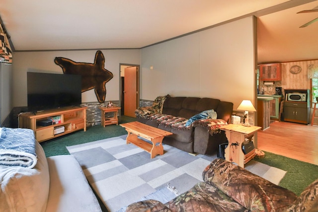 living room featuring ceiling fan, crown molding, and hardwood / wood-style floors