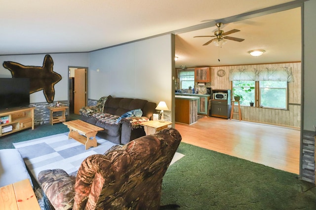 living room with ceiling fan and light hardwood / wood-style floors