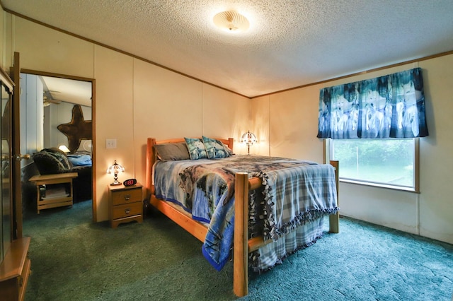 bedroom featuring a textured ceiling, ornamental molding, and dark colored carpet