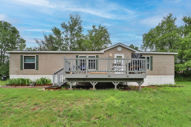 back of property featuring a deck and a yard