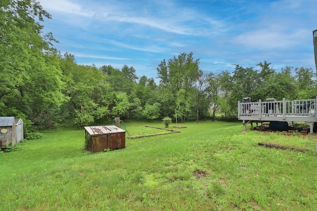 view of yard with a deck and a storage unit