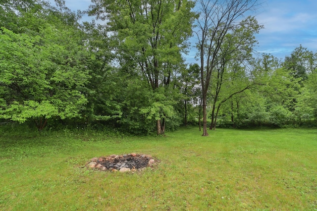 view of yard with a fire pit