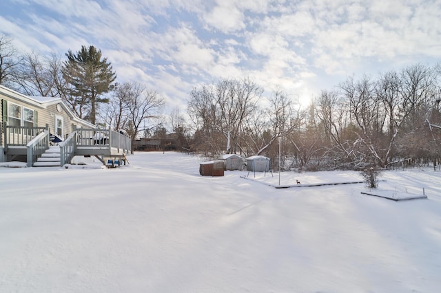 snowy yard with a wooden deck