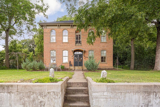 italianate house featuring french doors and a front yard