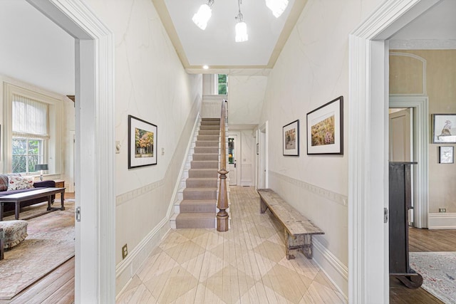 interior space with stairs and ornamental molding