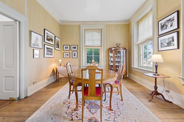 dining area featuring baseboards, plenty of natural light, and light wood-style floors