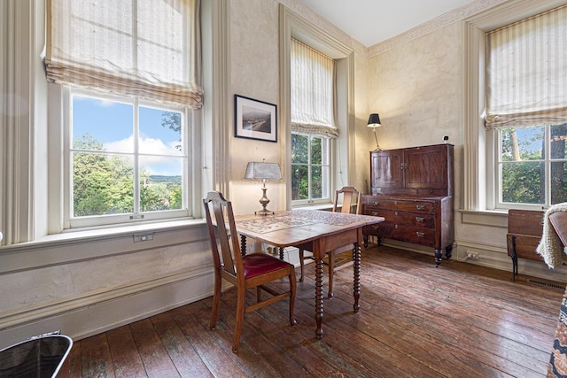 dining room featuring dark wood-style flooring and baseboards