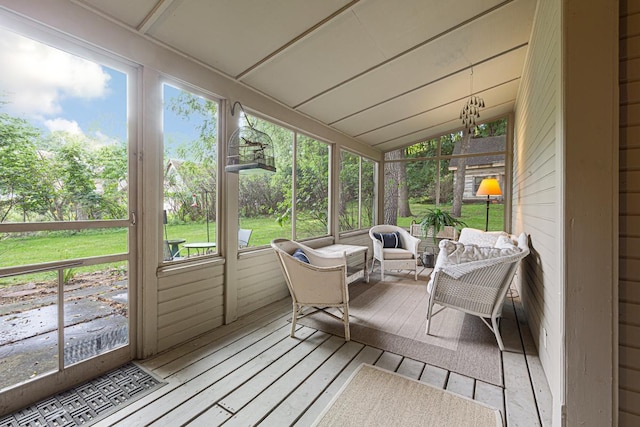 sunroom featuring vaulted ceiling