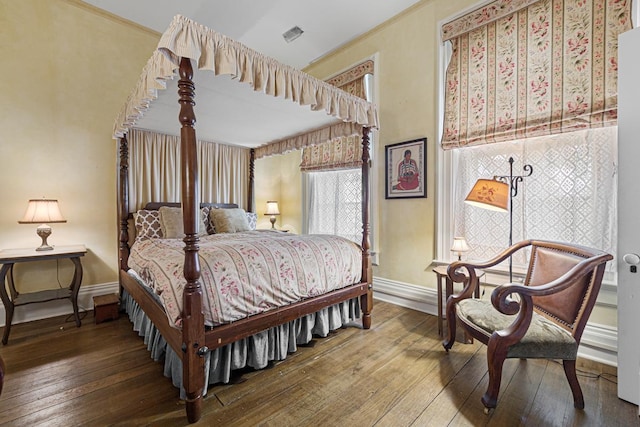 bedroom featuring wood finished floors and baseboards